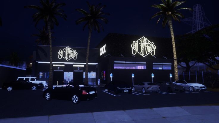 a building with palm trees in front of it at night