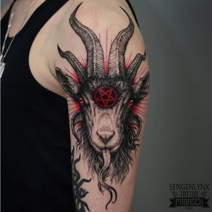 a goat head with red eyes and pentagramus on it's back shoulder