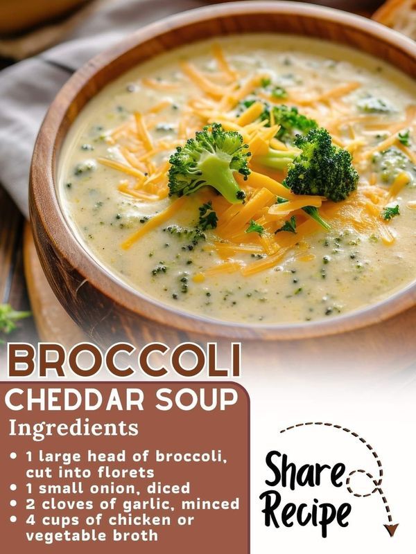 broccoli cheddar soup in a wooden bowl with cheese and bread on the side