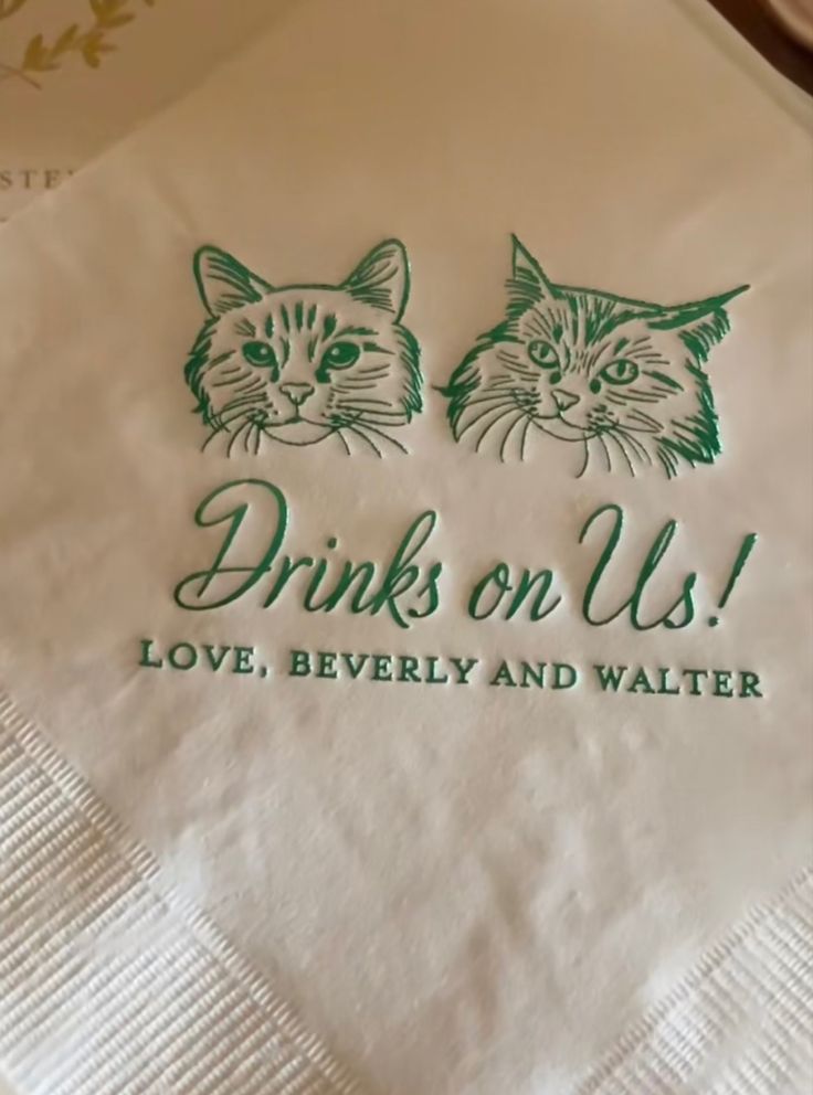 a napkin with two cats on it that says drinks on us love, beverly and walter