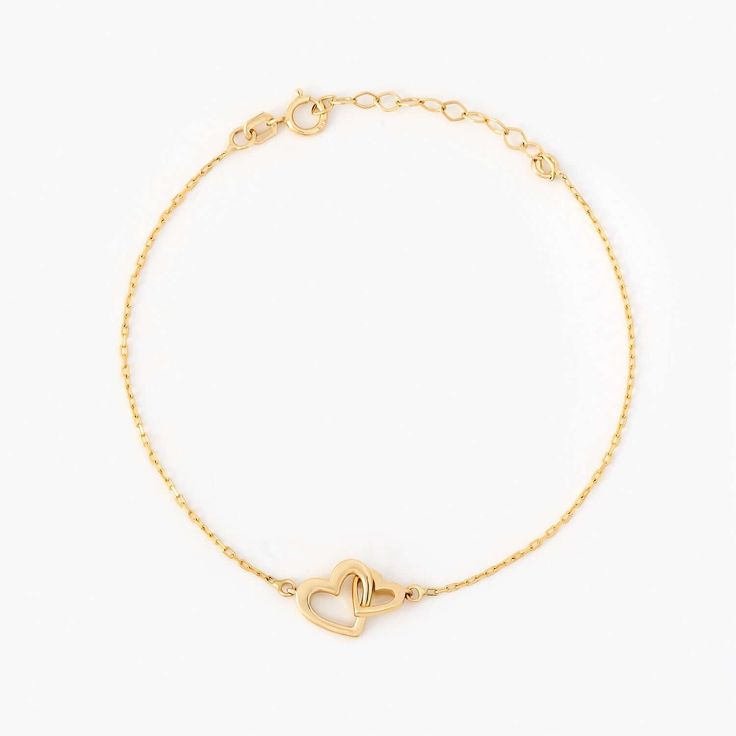 Showcase your love with the Interlocking Heart Bracelet in 14K Solid Gold. This meticulously crafted double heart bracelet for women is the perfect representation of eternal connection and affection. As a piece of 14k gold jewelry, it offers enduring shine and durability. Ideal as a couple bracelet or a thoughtful gift for her, this bracelet seamlessly blends style, sentiment, and quality. Its unique design and solid gold appeal make it a must-have addition to any jewelry collection. 14k solid g Sterling Silver Bracelets For Promise, Sterling Silver Yellow Gold Bracelets For Promise, Adjustable Yellow Gold Heart Bracelet For Anniversary, Yellow Gold Sterling Silver Bracelets For Promise, 14k Gold Adjustable Chain Bracelet For Anniversary, Heart-shaped 14k Yellow Gold Charm Bracelet, 14k Yellow Gold Heart Charm Bracelet, Yellow Gold 14k Heart Charm Bracelet, Yellow Gold Sterling Silver Heart Bracelet For Anniversary