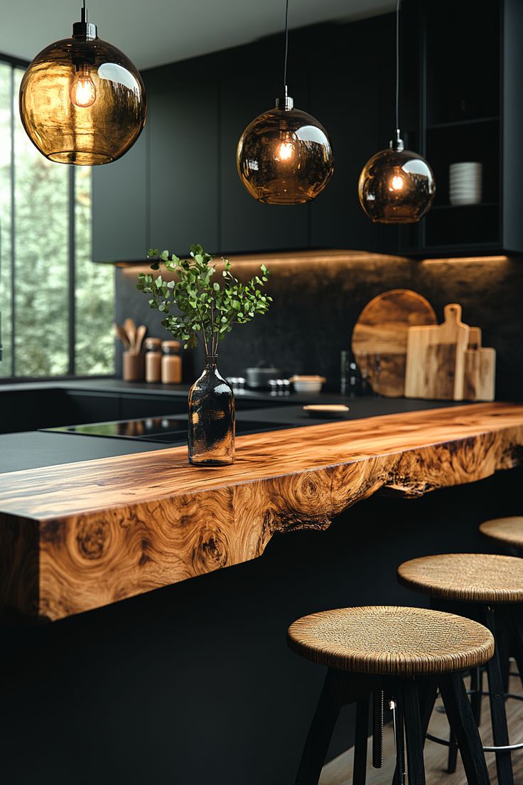 a kitchen island with stools and lights hanging from it's ceiling over the counter