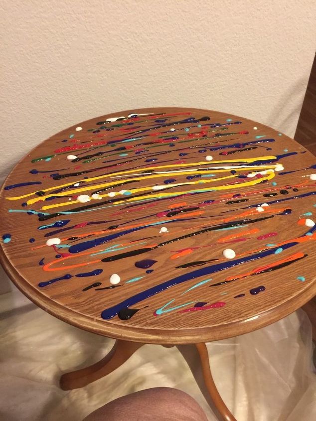 a wooden table with paint splattered on it