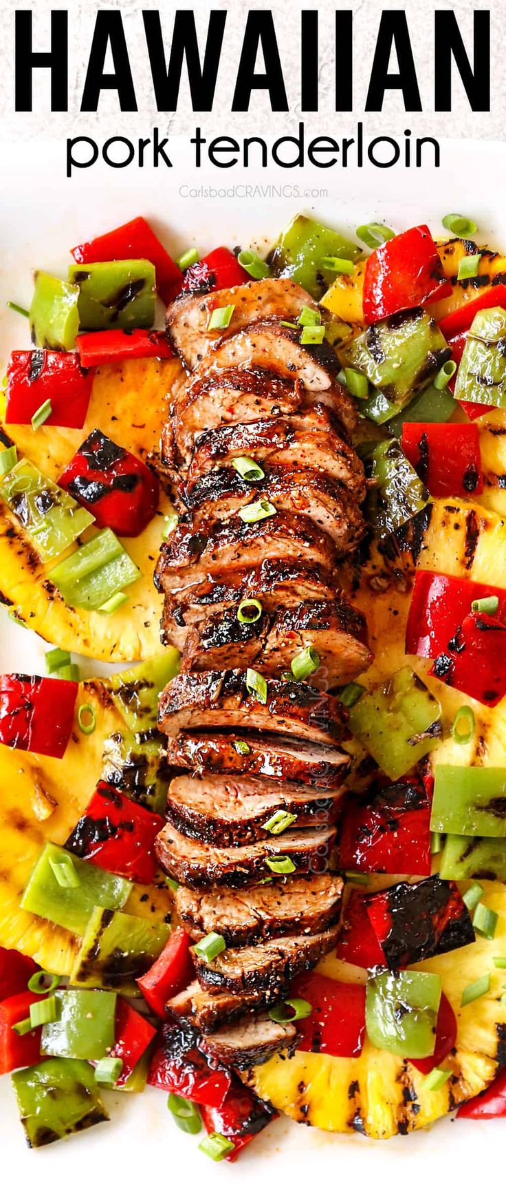 grilled pork with pineapple salsa and hawaiian fruit salad on a white platter