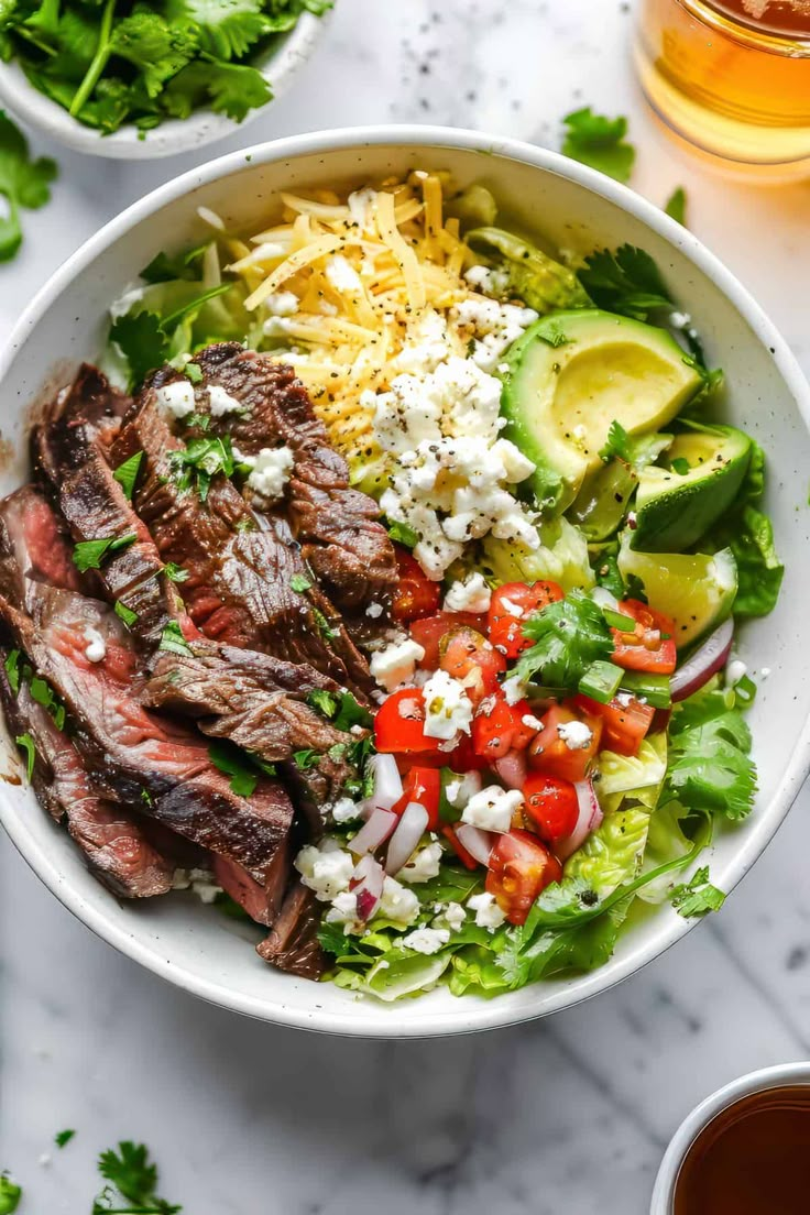 steak salad with tomatoes, cucumber, lettuce and feta cheese