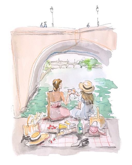 two women are sitting on a picnic blanket near the water and under an overpass