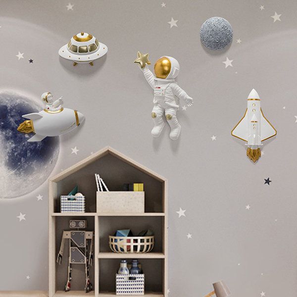 an astronaut themed room with stars and moon decals on the wall