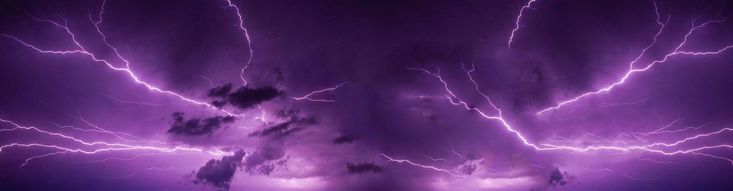 the sky is filled with purple lightning and it appears to be very dark in color