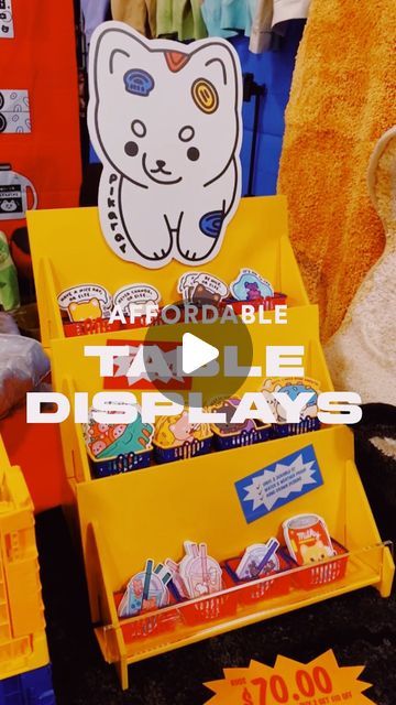 a display case filled with lots of different types of toys and books on top of a table