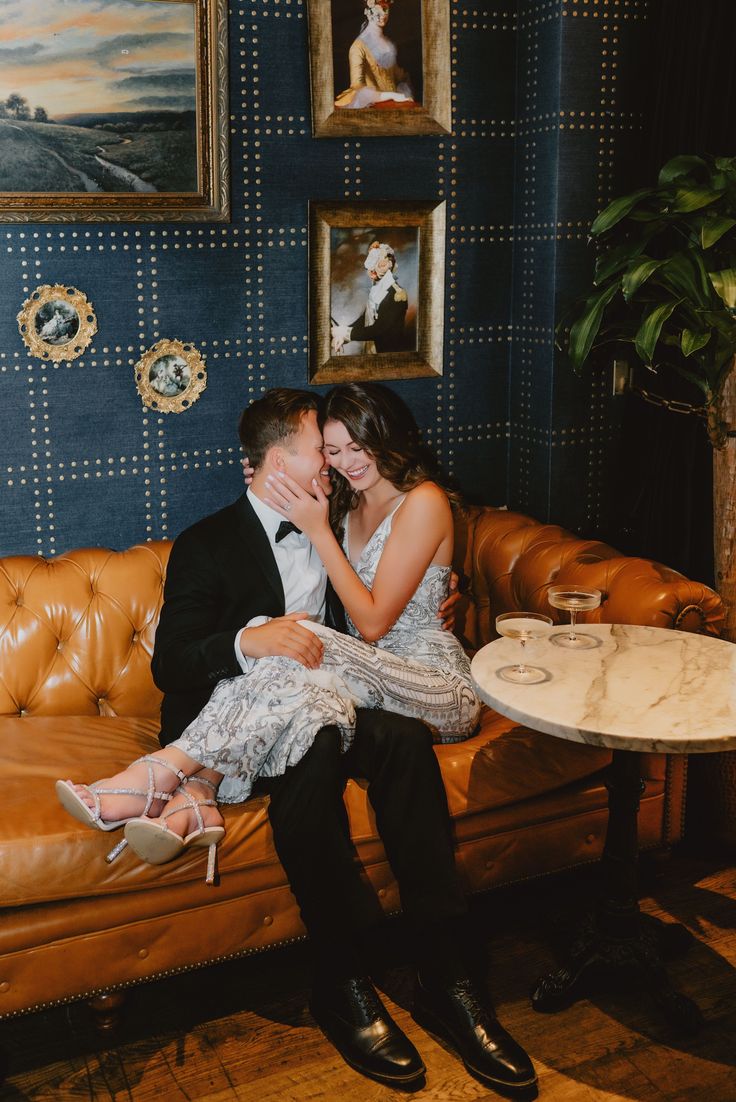 a man and woman sitting at a table kissing