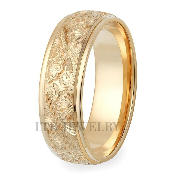 an intricately carved wedding ring with gold inlaying the center and floral design