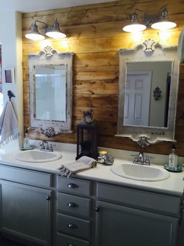 a bathroom with double sinks and two mirrors on the wall next to eachother