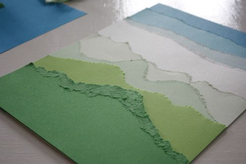 a piece of paper that has been cut into pieces with green and blue strips on it