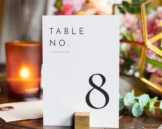 a table number sitting on top of a wooden table