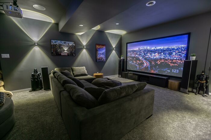 a living room filled with furniture and a flat screen tv mounted to the side of a wall