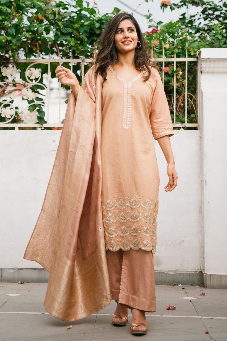 Nude cotton embroidered kurta in gota work. Paired with solid pant and dupatta.
Component: 3
Pattern: Embroidered
Type Of Work: Gota work
Neckline: Leaf neck
Sleeve Type: Three quarter
Fabric: Cotton, Cotton Silk, Banarasi
Color: Beige
Other Details: 
Banarasi dupatta
Scallop hem kurta
Occasion: Reception,Wedding - Aza Fashions Kurta Set For Women, Gota Work, Scallop Hem, Fashion App, Silk Pants, Kurta Set, Scalloped Hem, Set For Women, Aza Fashion