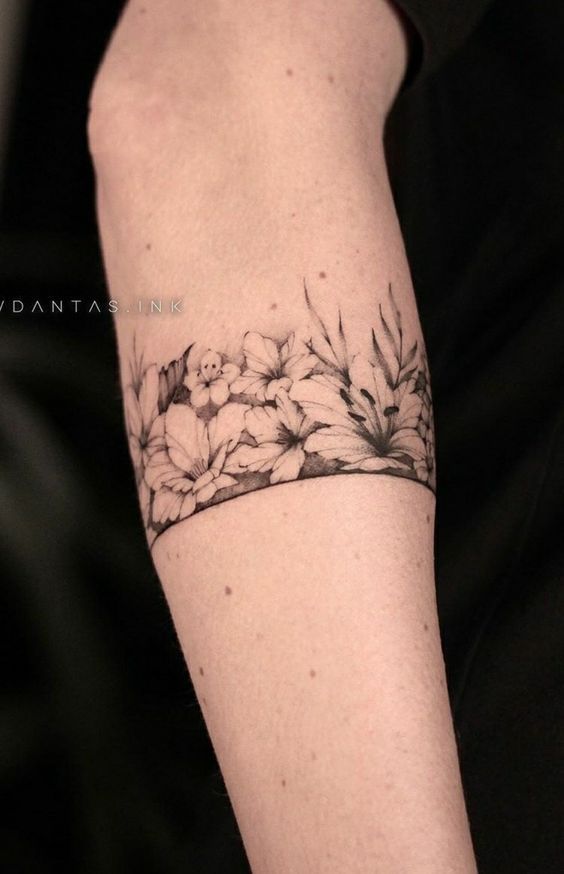 a woman's arm with flowers on it