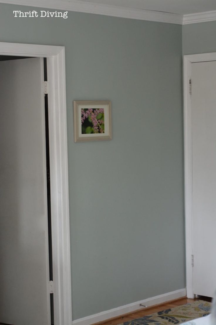 an empty room with blue walls and white trim