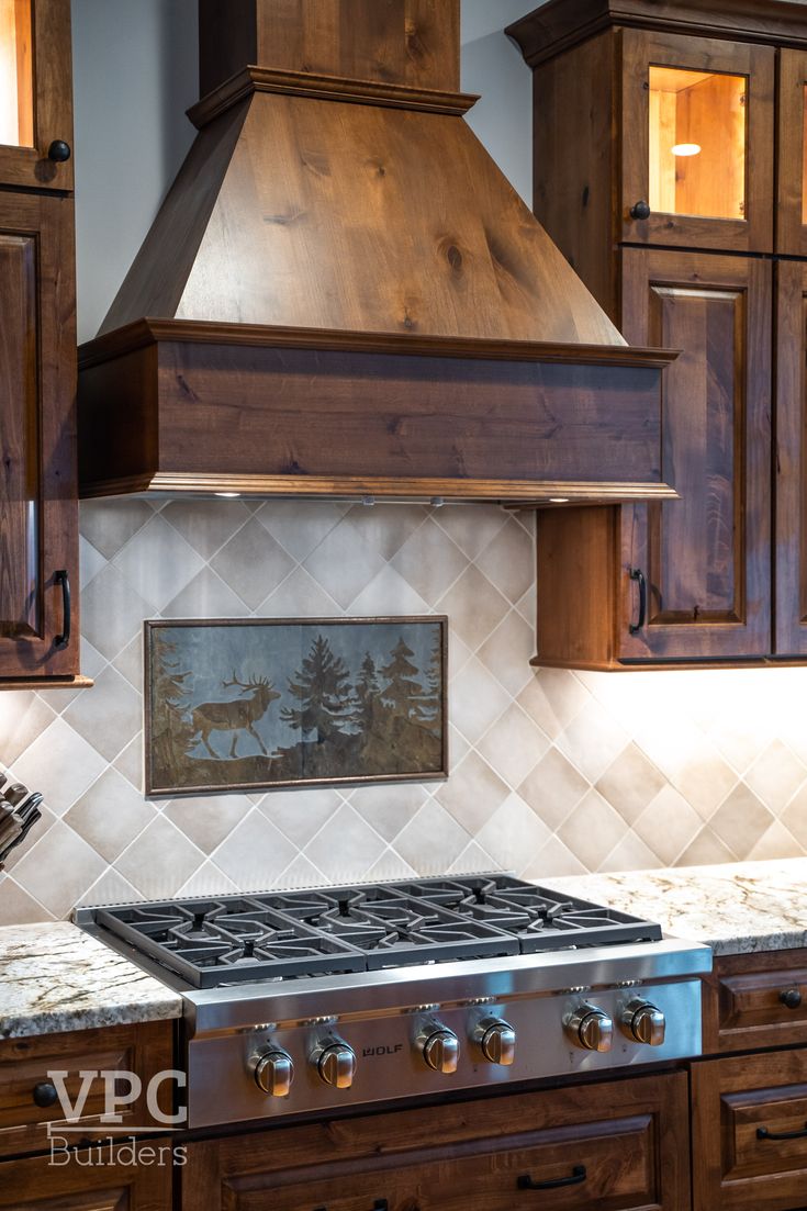 a stove top oven sitting inside of a kitchen next to wooden cupboards and cabinets