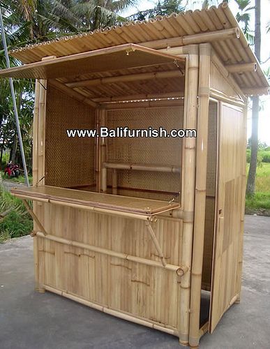 an outdoor hot tub in the shape of a house with bamboo roof and side walls