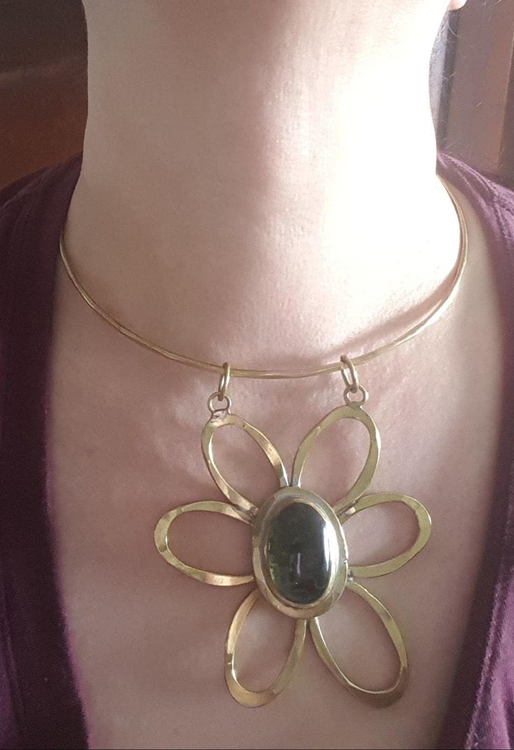 As far as Rafael jewellery goes, this is one of the best ones I have seen. It is brass and green glass. The pendant is 3 inches by 3 inches and the the ring is 4 3/8 inches wide. The flower is marked Rafael Canada at the back. C. 1970 and in nice condition and very showy! Follow me on instagram@jettesjewels. Modernist Bronze Brass Jewelry, Handmade Brass Modernist Jewelry, Handmade Modernist Brass Jewelry, Unique Brass Flower-shaped Jewelry, Vintage Brass Flower Jewelry, Flower-shaped Bronze Brass Jewelry, Bronze Brass Flower Jewelry, Bronze Brass Flower-shaped Jewelry, Unique Flower-shaped Brass Jewelry