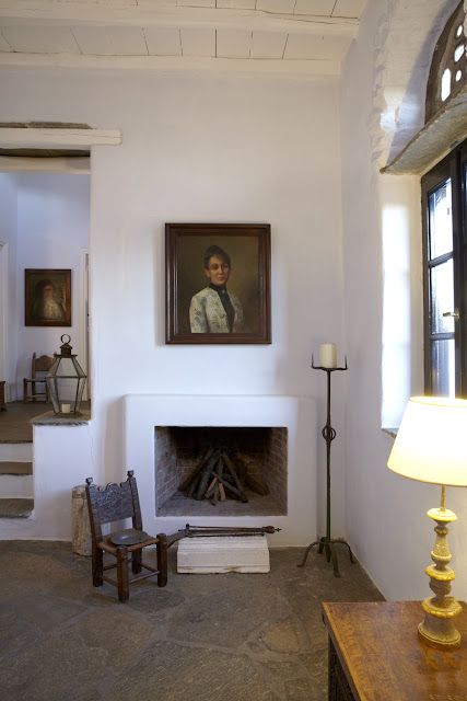 a living room filled with furniture and a fire place in front of a painting on the wall