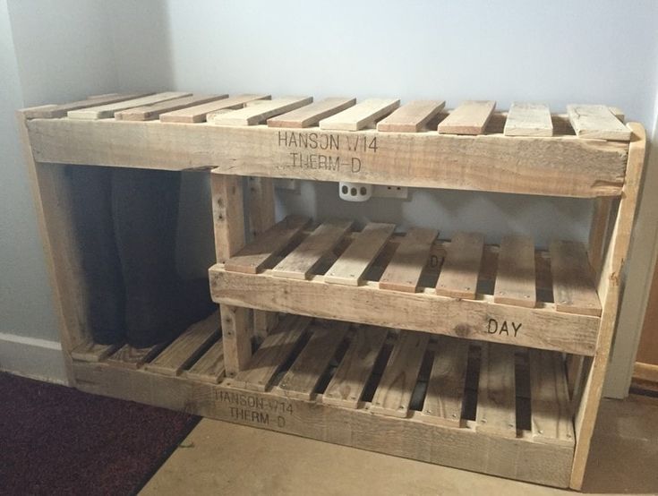 two wooden pallets stacked on top of each other in the corner of a room