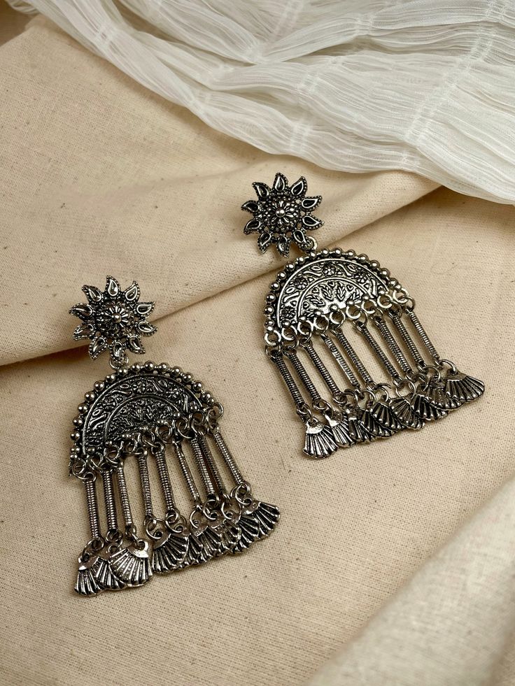 Look fabulous in our Parni Oxidised Earrings! With a classic tribal design, these lightweight earrings will add a touch of style to any outfit without weighing you down. Get a traditional look with a modern appeal! Please Note: We do not accept returns of earrings due to hygiene reasons Simple Indian Earrings, Oxidised Jewellery Earrings, Aesthetic Eid, Jewellery Shoot, Traditional Accessories, Oxidised Earrings, Trendy Jewellery, Oxidized Silver Earrings, Oxidised Silver Jewelry