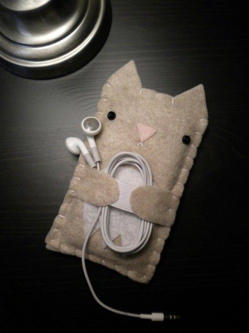 an ipod charger with a cat design on it and earphones attached to the cover