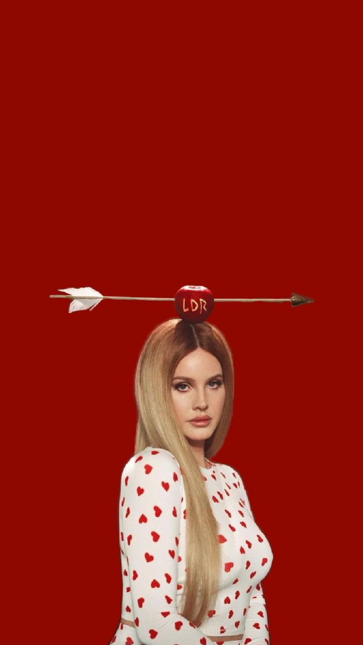 a woman with long blonde hair and an arrow on her head is standing in front of a red background