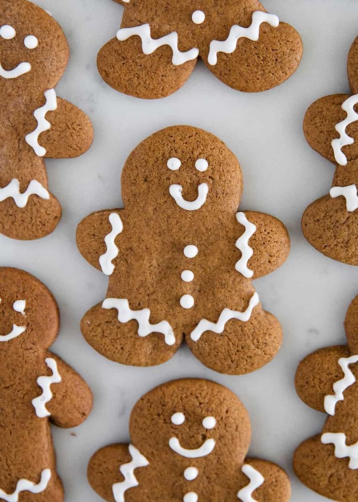 several ginger cookies with white icing on them