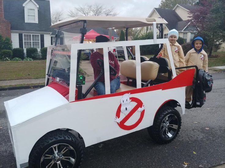 three people are riding in a golf cart