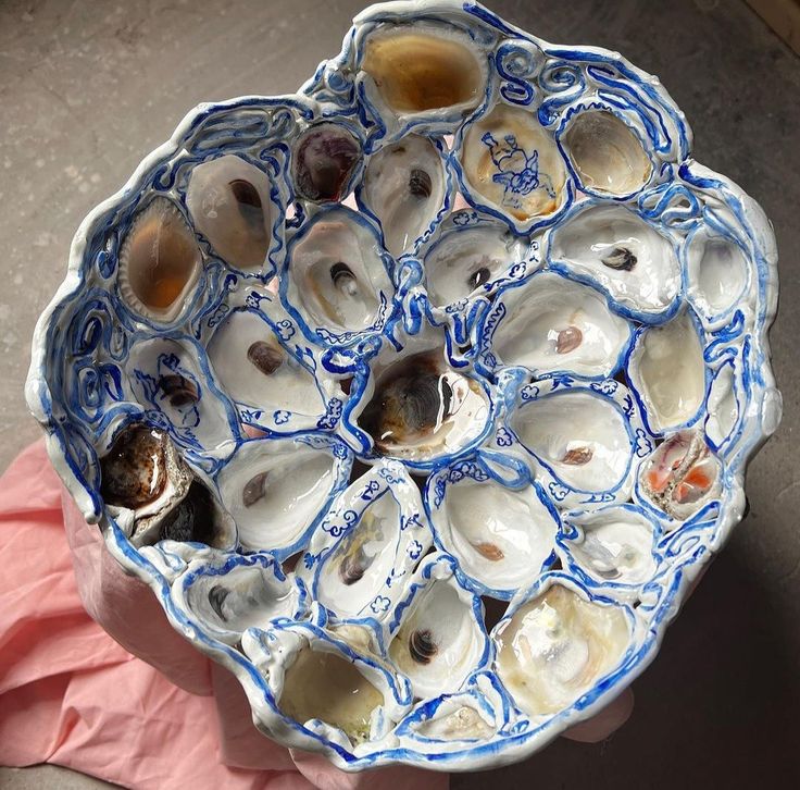 a blue and white bowl filled with oysters