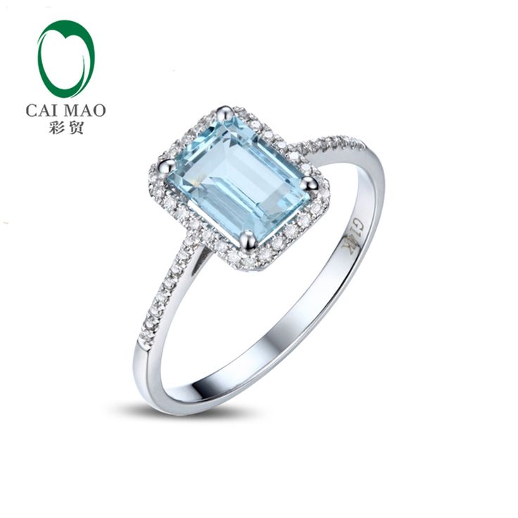 a ring with an aqua blue topazte and diamonds on the sides, in white gold