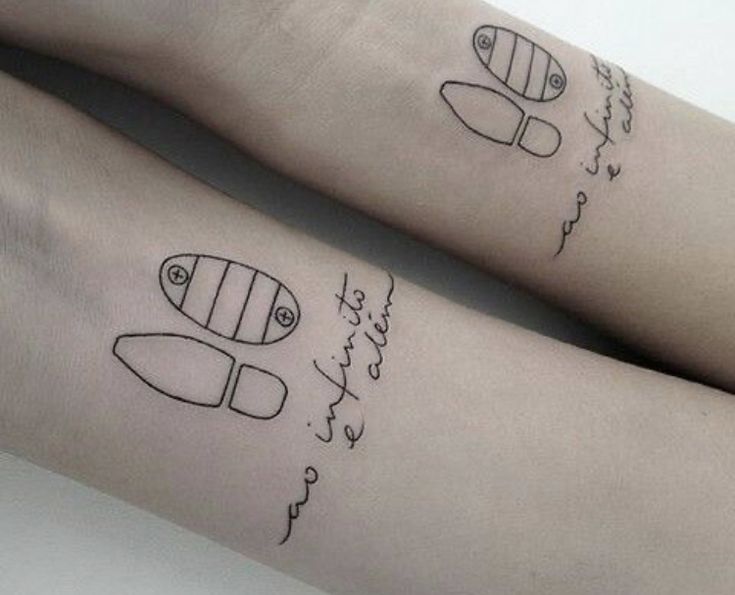 two people with matching tattoos on their legs, one has a fish and the other has a surfboard