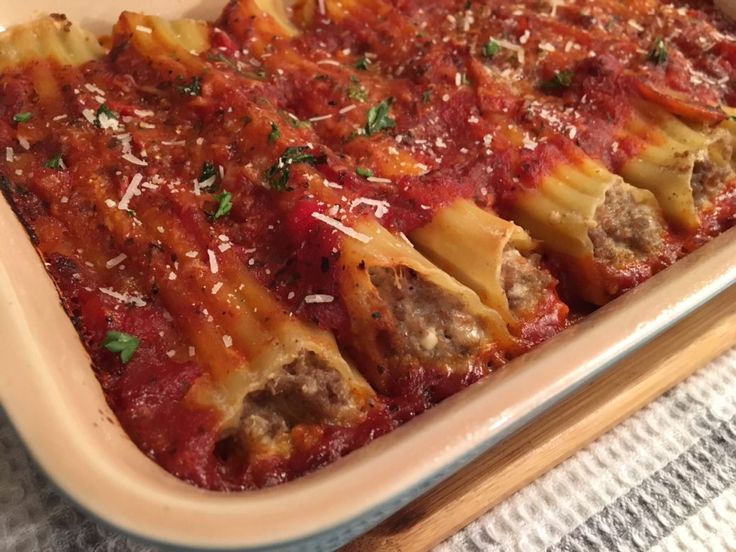 a casserole dish filled with meat and sauce