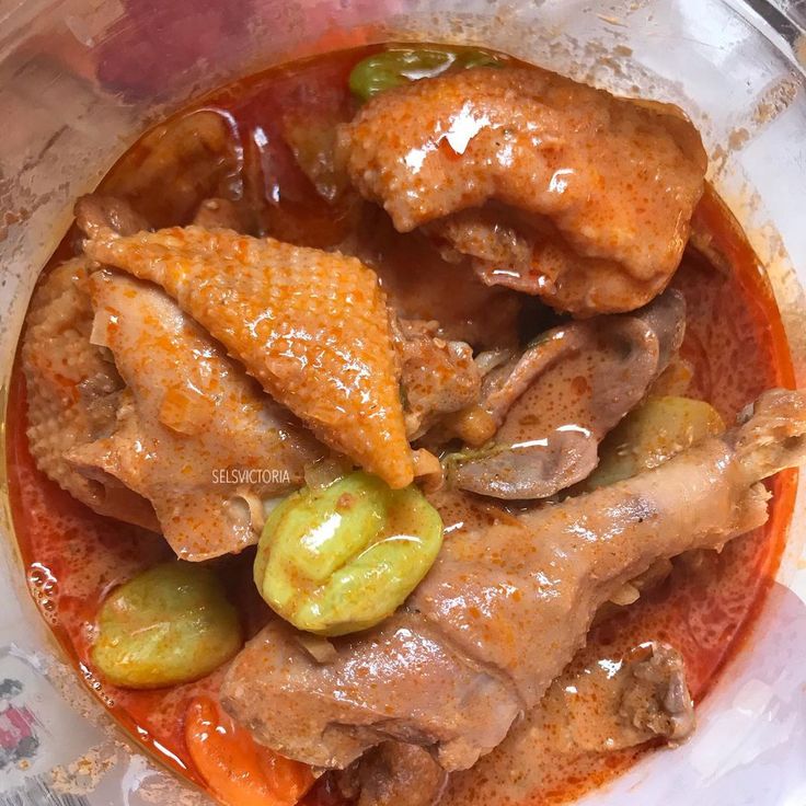 a bowl filled with meat and vegetables covered in sauce