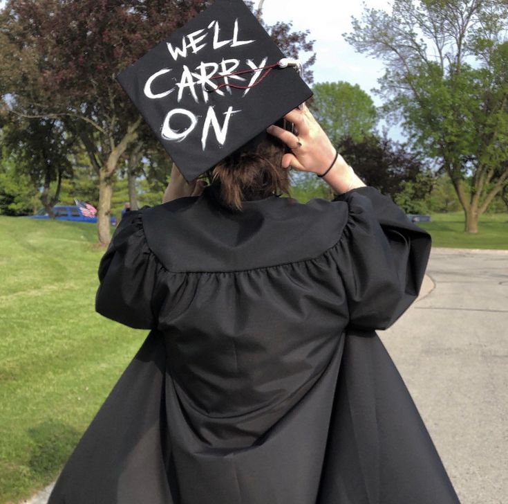 a woman wearing a graduation cap with the words we'll carry on written on it