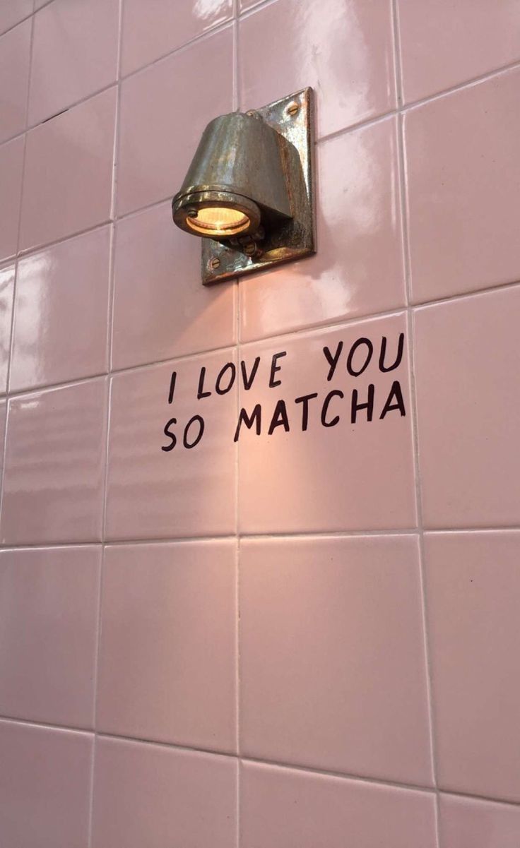 i love you so matcha written on the wall next to a toilet paper roll