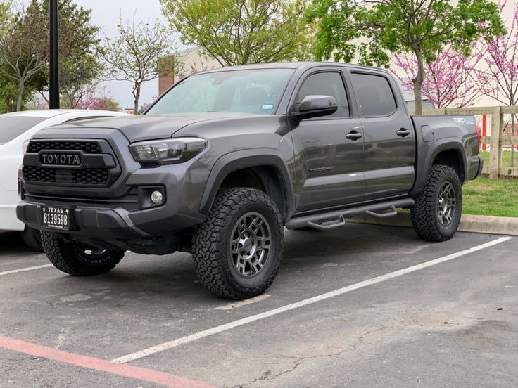 a gray toyota truck parked in a parking lot