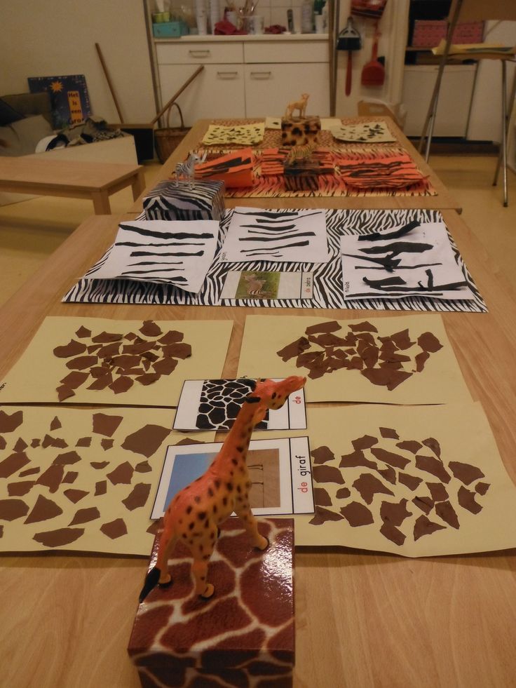 several giraffes and zebra prints are on the table