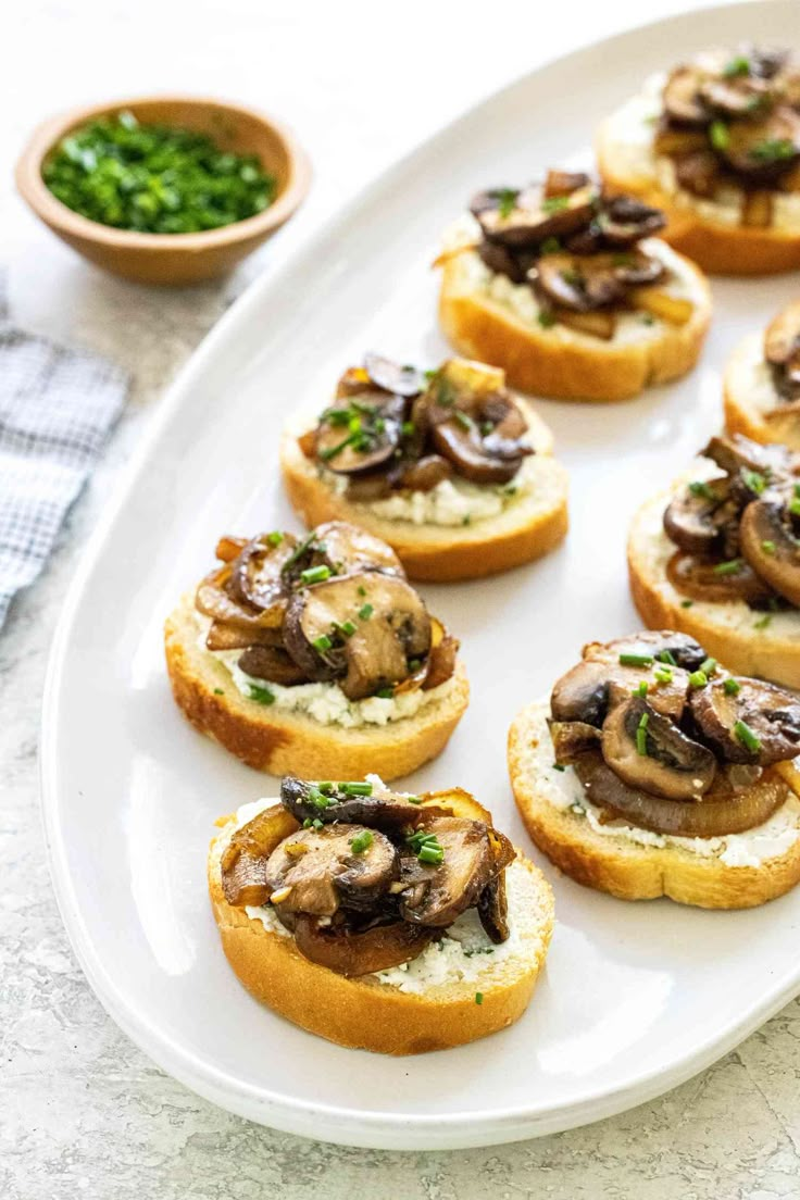 small appetizers with mushrooms are on a white plate