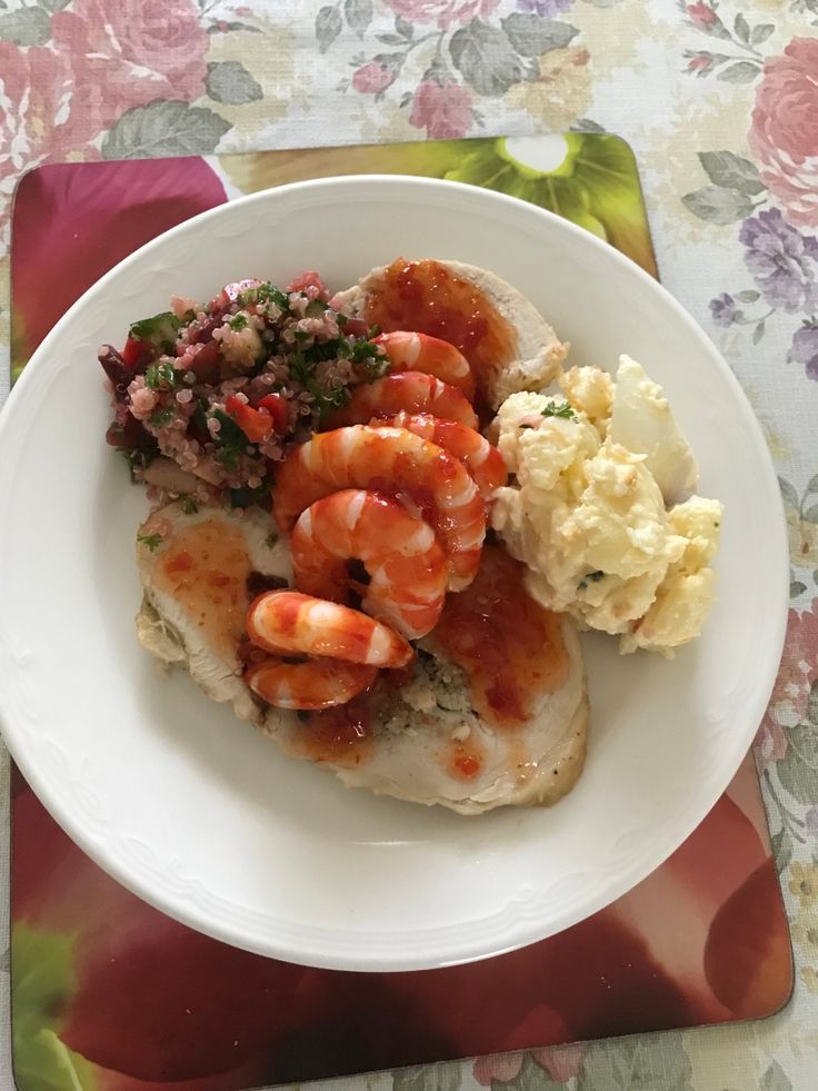 a white plate topped with shrimp, cauliflower and mashed potatoes