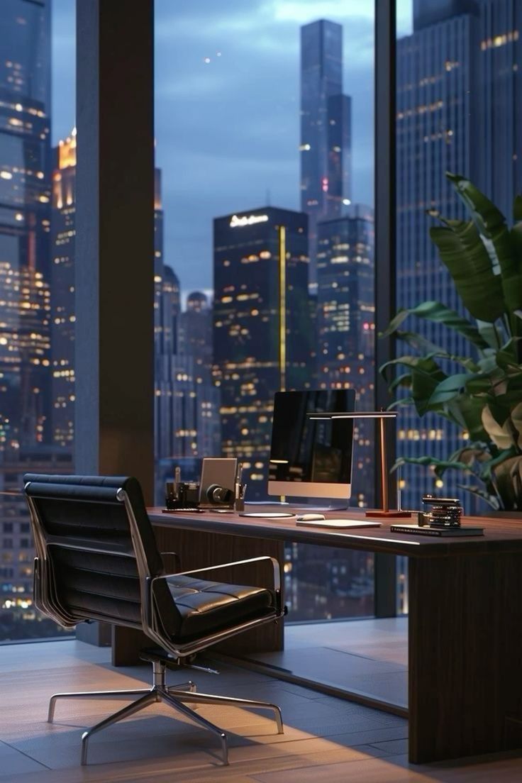 an office with a view of the city at night