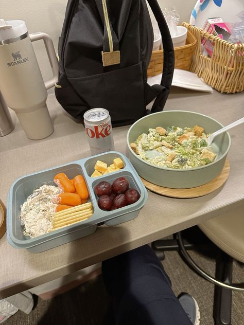 a person sitting at a table with two trays of food