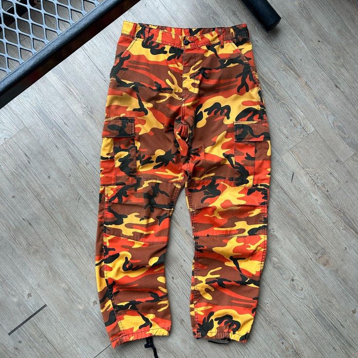 VINTAGE ' Military Orange Camo Cargo Pants sz M-Reg W33 L32 CONDITION : Wear and fading from age. No major flaws. Overall great condition/ wear ! These pants have been washed* - Please review pictures* TAGGED SIZE : ** Adult Mens M - REG* ( Fits : Mens W31-34 L32 *adjustable waist straps ) MEASUREMENTS : *Please see photos above for measurements. *Disclaimer: All measurements are in inches and are taken laying flat on the ground* * Waist measurement taken hip to hip * Length measurement taken fr Orange Camo, Camo Cargo Pants, Length Measurement, Vintage Military, Waist Measurement, On The Ground, Mens Trousers, Hip Length, Cargo Pants