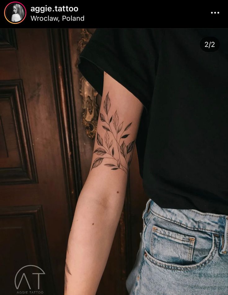 a woman's arm with a tattoo on it, and an arrow in the middle