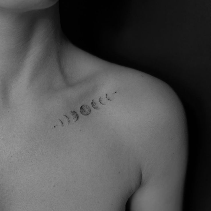 a woman's chest with three phases of the moon tattooed on her left side