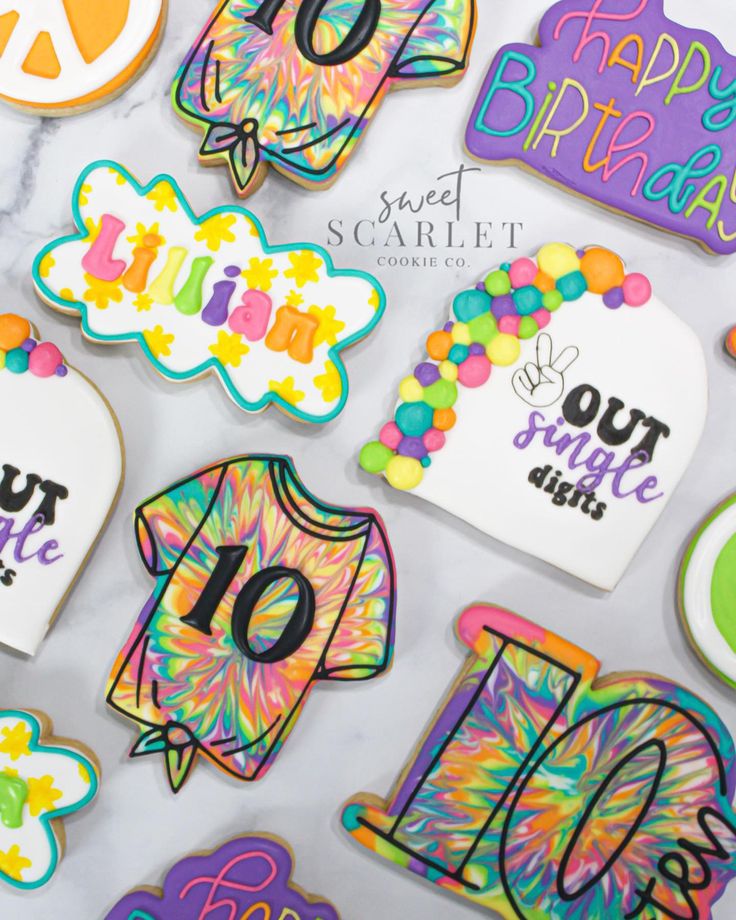 decorated birthday cookies are displayed on a table