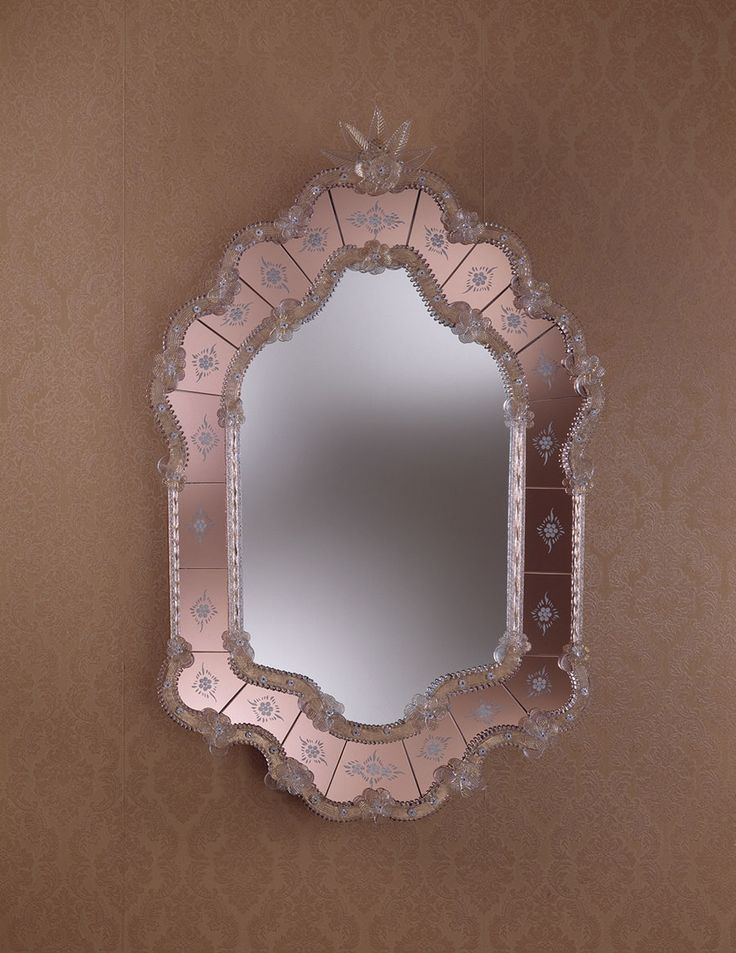 a mirror that is on the wall above a sink in a room with brown walls